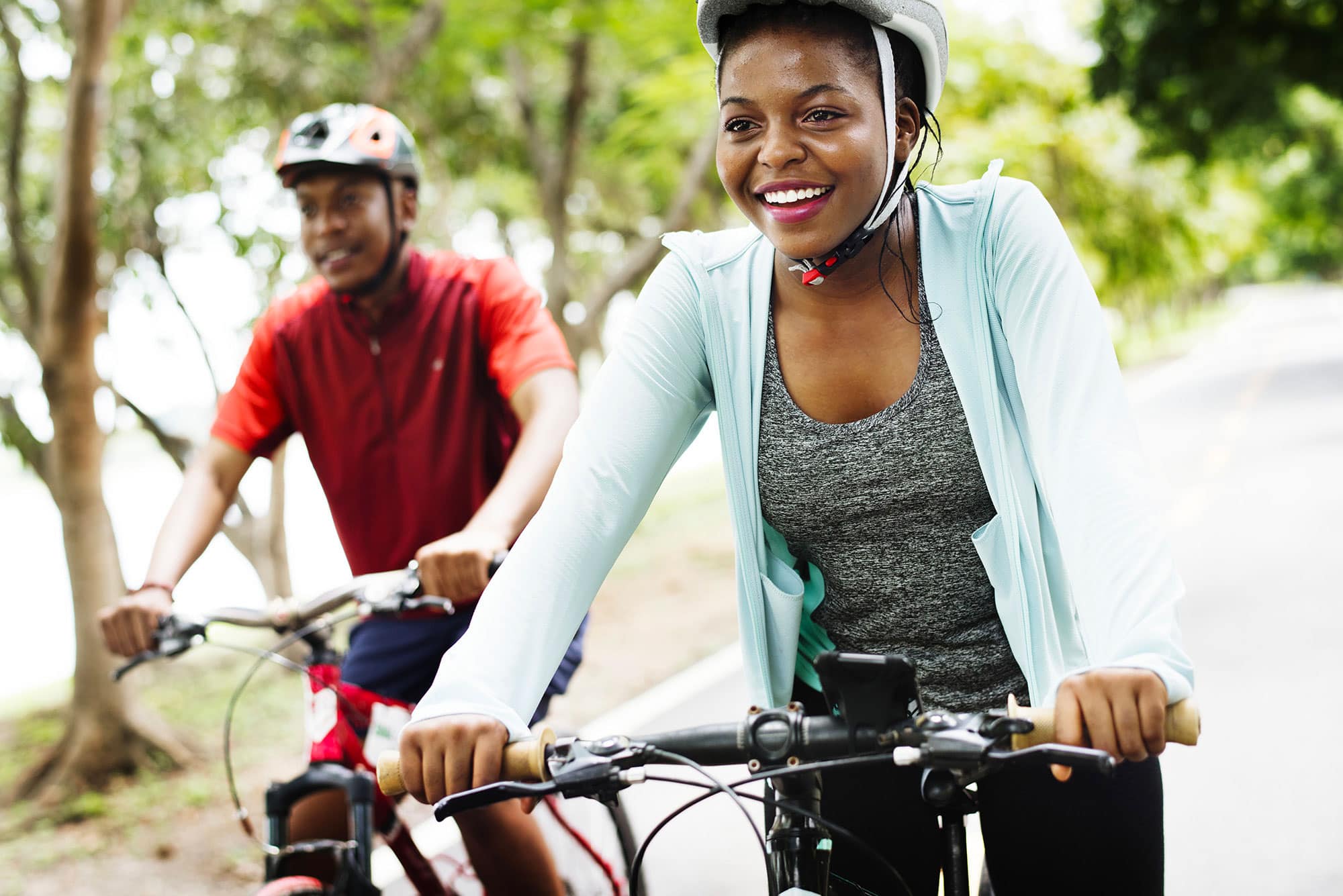 Cyclist couple riding together in a park